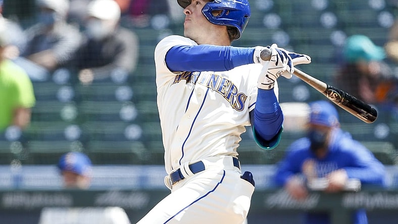 May 2, 2021; Seattle, Washington, USA; Seattle Mariners second baseman Dylan Moore (25) hits an RBI-single against the Los Angeles Angels during the fourth inning at T-Mobile Park. Mandatory Credit: Joe Nicholson-USA TODAY Sports