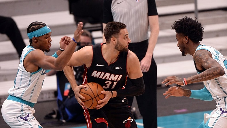 May 2, 2021; Charlotte, North Carolina, USA;  Miami Heat guard Max Strus (31) looks to pass as he is defended by Charlotte Hornets guard Devonte  Graham (4) and forward Jalen McDaniels (4) during the first half at the Spectrum Center. Mandatory Credit: Sam Sharpe-USA TODAY Sports