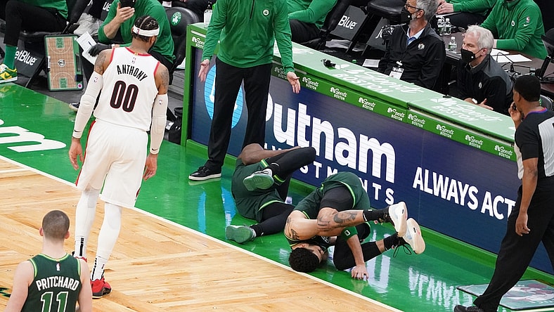 May 2, 2021; Boston, Massachusetts, USA; Boston Celtics forward Jayson Tatum (0) and guard Jaylen Brown (7) fall to the ground as head coach Brad Stevens looks on as they take on the Portland Trail Blazers in the fourth quarter at TD Garden. Mandatory Credit: David Butler II-USA TODAY Sports