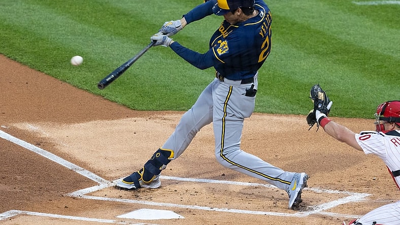 May 3, 2021; Philadelphia, Pennsylvania, USA; Milwaukee Brewers left fielder Christian Yelich (22) hits a single during the first inning against the Philadelphia Phillies at Citizens Bank Park. Mandatory Credit: Bill Streicher-USA TODAY Sports