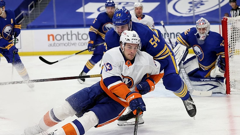 May 3, 2021; Buffalo, New York, USA; Buffalo Sabres defenseman Mattias Samuelsson (54) knocks down New York Islanders center Mathew Barzal (13) as he skates with the puck during the first period at KeyBank Center. Mandatory Credit: Timothy T. Ludwig-USA TODAY Sports
