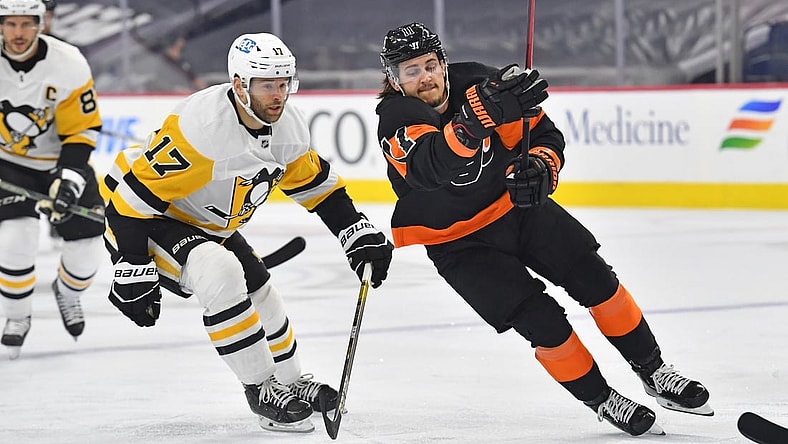 May 3, 2021; Philadelphia, Pennsylvania, USA;  Philadelphia Flyers right wing Travis Konecny (11) skates past Pittsburgh Penguins right wing Bryan Rust (17) during the first period at Wells Fargo Center. Mandatory Credit: Eric Hartline-USA TODAY Sports