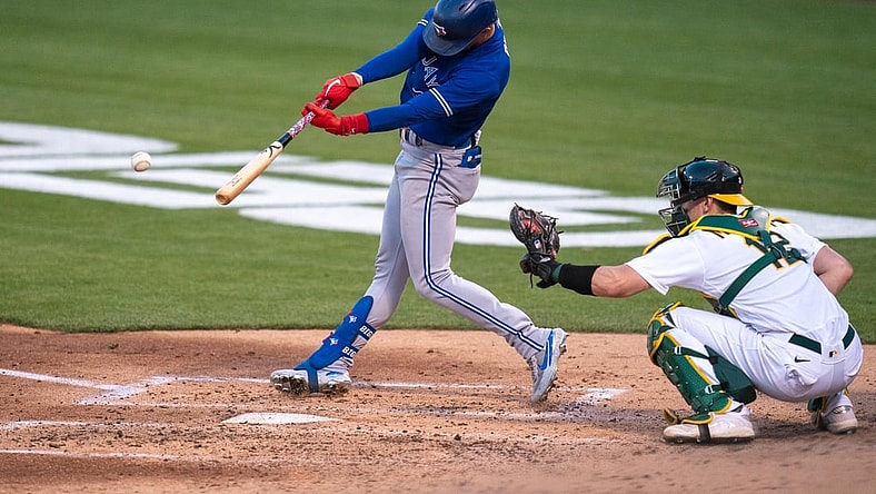 May 3, 2021; Oakland, California, USA; Toronto Blue Jays right fielder Cavan Biggio (8) hits a single during the third inning against the Oakland Athletics at RingCentral Coliseum. Mandatory Credit: Neville E. Guard-USA TODAY Sports