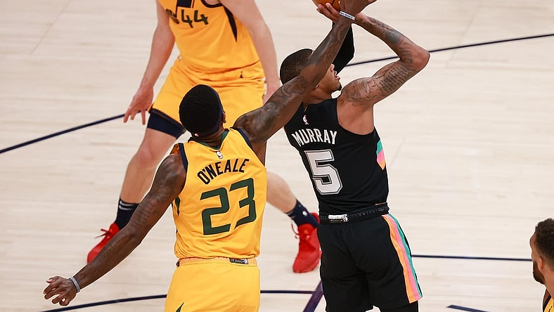 May 3, 2021; Salt Lake City, Utah, USA;  Utah Jazz forward Royce O'Neale (23) blocks the shot of San Antonio Spurs guard Dejounte Murray (5) during the second quarter at Vivint Arena. Mandatory Credit: Chris Nicoll-USA TODAY Sports
