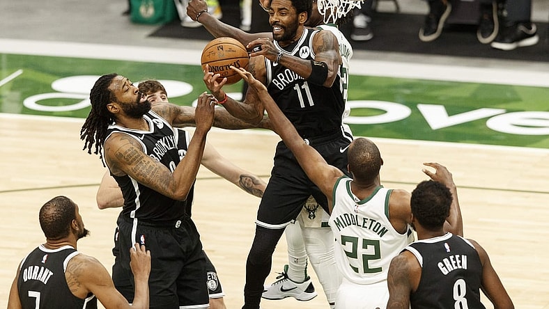 May 4, 2021; Milwaukee, Wisconsin, USA;  Brooklyn Nets center DeAndre Jordan (6), guard Kyrie Irving (11) and  Milwaukee Bucks forward Khris Middleton (22) reach for a rebound during the first quarter at Fiserv Forum. Mandatory Credit: Jeff Hanisch-USA TODAY Sports