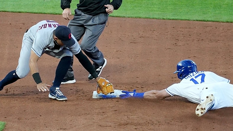 May 4, 2021; Kansas City, Missouri, USA; Cleveland Indians second baseman Cesar Hernandez (7) misses the tag on Kansas City Royals right fielder Hunter Dozier (17) who reaches second safely in the second inning at Kauffman Stadium. Mandatory Credit: Denny Medley-USA TODAY Sports