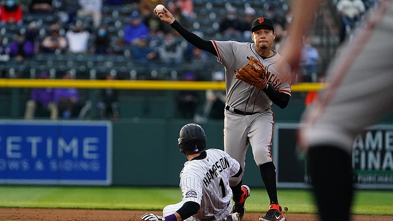 May 4, 2021; Denver, Colorado, USA; San Francisco Giants second baseman Wilmer Flores (41) attempts to turn a double play over Colorado Rockies second baseman Garrett Hampson (1) in the first inning against the at Coors Field. Mandatory Credit: Ron Chenoy-USA TODAY Sports