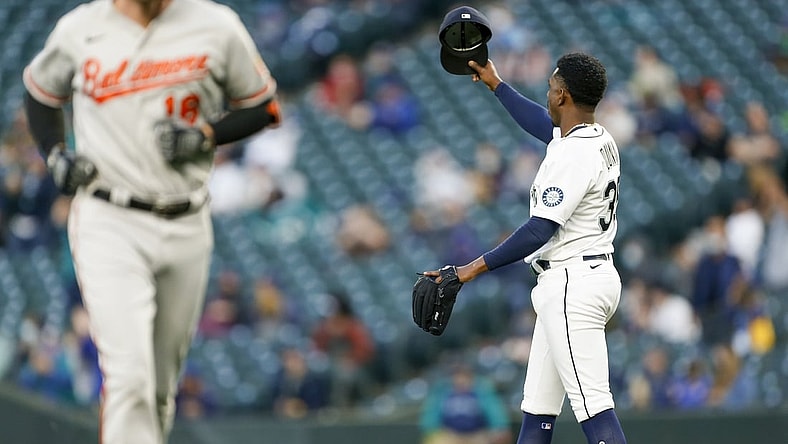 May 4, 2021; Seattle, Washington, USA; Seattle Mariners starting pitcher Justin Dunn (35) tips his hat following a catch along the wall on a fly ball by Baltimore Orioles first baseman Trey Mancini (16) during the third inning at T-Mobile Park. Mandatory Credit: Joe Nicholson-USA TODAY Sports