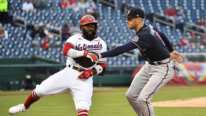 May 5, 2021; Washington, District of Columbia, USA; Washington Nationals second baseman Josh Harrison (5) is tagged out by Atlanta Braves first baseman Freddie Freeman (5) during the first inning at Nationals Park. Mandatory Credit: Brad Mills-USA TODAY Sports