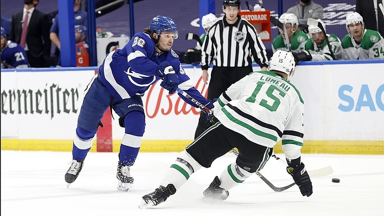 May 5, 2021; Tampa, Florida, USA; Tampa Bay Lightning defenseman Mikhail Sergachev (98) passes the puck as Dallas Stars left wing Blake Comeau (15) defends during the first period at Amalie Arena. Mandatory Credit: Kim Klement-USA TODAY Sports