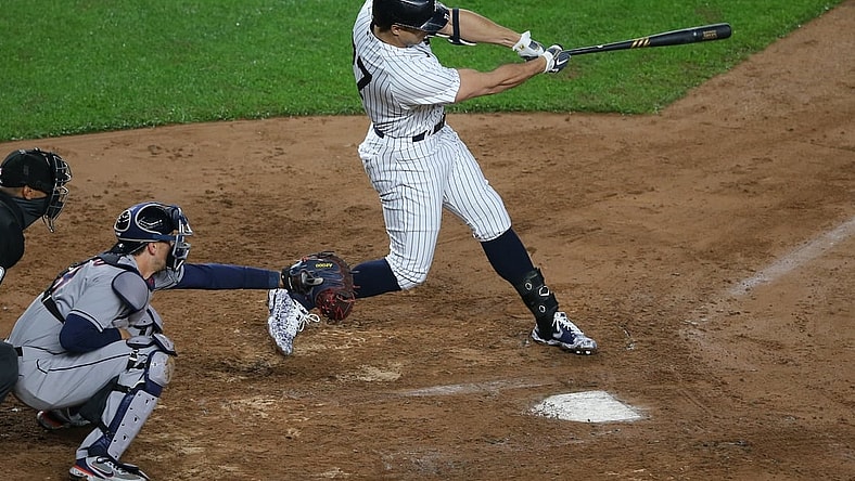May 5, 2021; Bronx, New York, USA; New York Yankees designated hitter Giancarlo Stanton (27) hits a two run home run against the Houston Astros during the third inning at Yankee Stadium. Mandatory Credit: Brad Penner-USA TODAY Sports