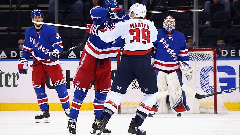 May 5, 2021; New York, New York, USA; Pavel Buchnevich #89 of the New York Rangers takes a high-sticking penalty on Anthony Mantha #39 of the Washington Capitals during the second period at Madison Square Garden. Mandatory Credit:  Bruce Bennett/POOL PHOTOS-USA TODAY Sports