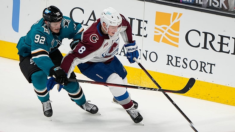 May 5, 2021; San Jose, California, USA;  San Jose Sharks left wing Rudolfs Balcers (92) and Colorado Avalanche defenseman Cale Makar (8) fight for control of the puck during the second period at the SAP Center at San Jose. Mandatory Credit: Stan Szeto-USA TODAY Sports