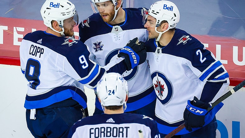 May 5, 2021; Calgary, Alberta, CAN; Winnipeg Jets left wing Adam Lowry (17) celebrates his goal with teammates against the Calgary Flames during the second period at Scotiabank Saddledome. Mandatory Credit: Sergei Belski-USA TODAY Sports