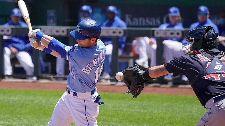 May 6, 2021; Kansas City, Missouri, USA; With Kansas City Royals left fielder Andrew Benintendi (16) swings at a pitch as Cleveland Indians catcher Rene Rivera (46) attempts to make a throw to second base but drops the ball in the first inning at Kauffman Stadium. Mandatory Credit: Denny Medley-USA TODAY Sports