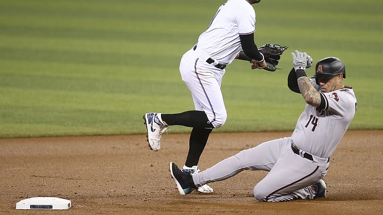 May 6, 2021; Miami, Florida, USA; Miami Marlins shortstop Miguel Rojas (19) throws to first after forcing out Arizona Diamondbacks third baseman Asdrubal Cabrera (14) during the first inning at loanDepot park. Mandatory Credit: Sam Navarro-USA TODAY Sports