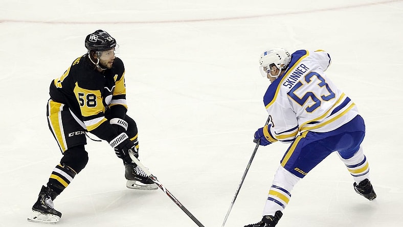 May 6, 2021; Pittsburgh, Pennsylvania, USA;  Pittsburgh Penguins defenseman Kris Letang (58) defends Buffalo Sabres left wing Jeff Skinner (53) during the first period at PPG Paints Arena. Mandatory Credit: Charles LeClaire-USA TODAY Sports