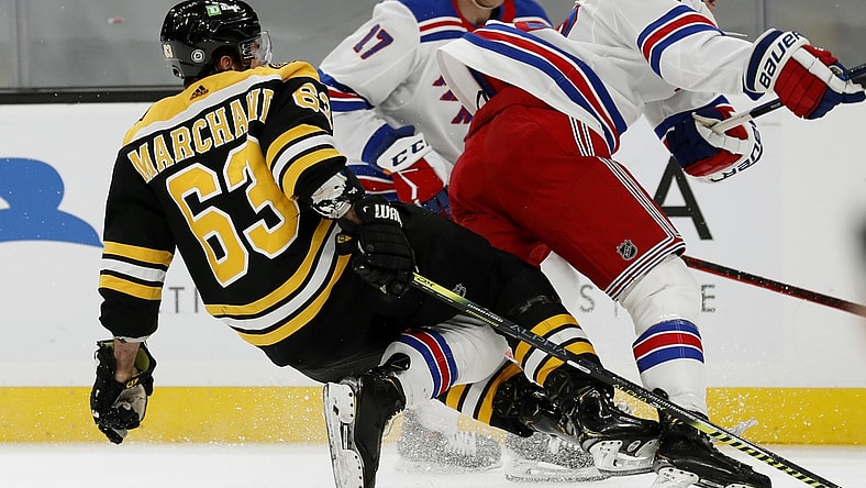 May 6, 2021; Boston, Massachusetts, USA; New York Rangers defenseman Adam Fox (23) collides with Boston Bruins center Brad Marchand (63) during the first period at TD Garden. Mandatory Credit: Winslow Townson-USA TODAY Sports