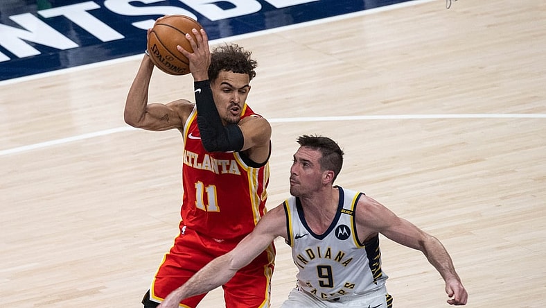 May 6, 2021; Indianapolis, Indiana, USA; Atlanta Hawks guard Trae Young (11) catches the ball while Indiana Pacers guard T.J. McConnell (9) defends in the second quarter at Bankers Life Fieldhouse. Mandatory Credit: Trevor Ruszkowski-USA TODAY Sports