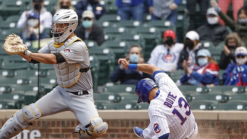 May 7, 2021; Chicago, Illinois, USA; Chicago Cubs second baseman David Bote (13) scores as Pittsburgh Pirates catcher Jacob Stallings (58) waits for the ball during the second inning at Wrigley Field. Mandatory Credit: Kamil Krzaczynski-USA TODAY Sports