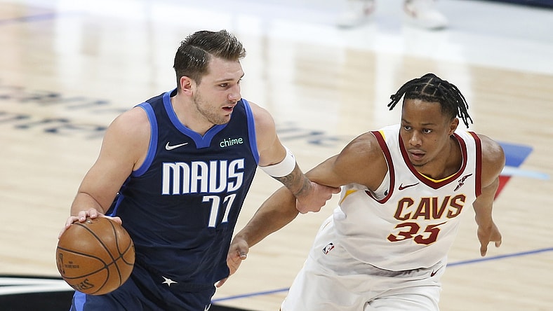 May 7, 2021; Dallas, Texas, USA; Dallas Mavericks guard Luka Doncic (77) drives against Cleveland Cavaliers guard Brodric Thomas (33) during the first quarter at American Airlines Center. Mandatory Credit: Tim Heitman-USA TODAY Sports
