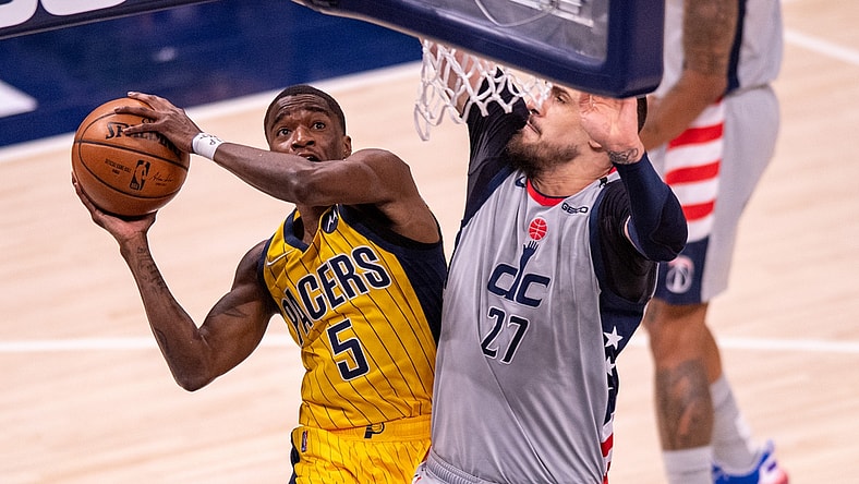 May 8, 2021; Indianapolis, Indiana, USA;  Indiana Pacers guard Edmond Sumner (5) shoots against Washington Wizards center Alex Len (27) during the first half of an NBA basketball game at Bankers Life Fieldhouse. Mandatory Credit: Doug McSchooler-USA TODAY Sports