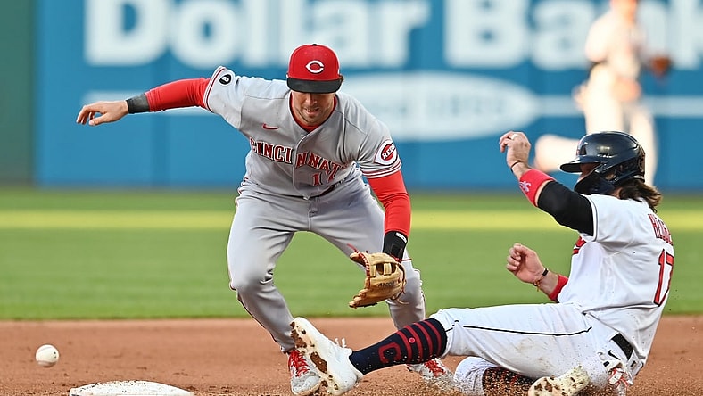 May 8, 2021; Cleveland, Ohio, USA; Cleveland Indians catcher Austin Hedges (right) is safe at second base as Cincinnati Reds shortstop Kyle Farmer (left) cannot handle the throw during the fourth inning at Progressive Field. Mandatory Credit: Ken Blaze-USA TODAY Sports