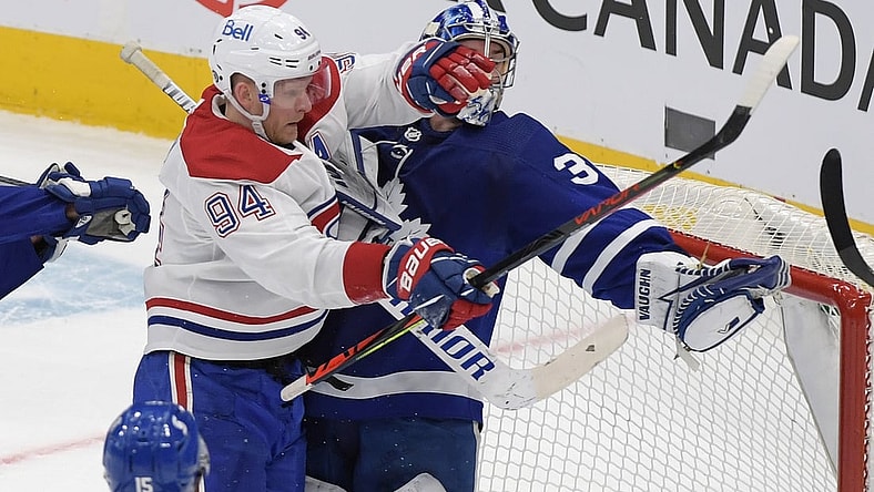 May 8, 2021; Toronto, Ontario, CAN;  Toronto Maple Leafs goalie Jack Campbell (36) holds the puck in his glove as he is bodychecked by Montreal Canadiens forward Corey Perry (94) in the first period at Scotiabank Arena. Mandatory Credit: Dan Hamilton-USA TODAY Sports