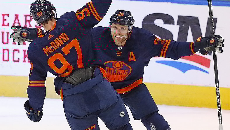 May 8, 2021; Edmonton, Alberta, CAN; Edmonton Oilers forward Connor McDavid (97) celebrates his 100th point of the season on a goal by forward Leon Draisaitl (29) against the Vancouver Canucks at Rogers Place. Mandatory Credit: Perry Nelson-USA TODAY Sports