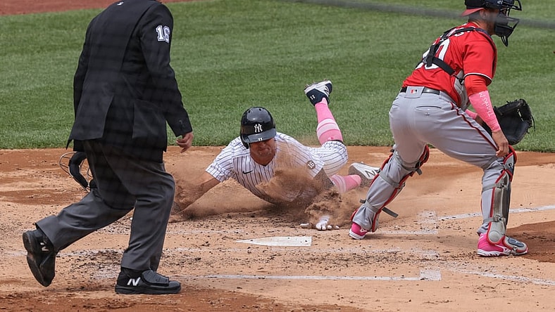 May 9, 2021; Bronx, New York, USA; New York Yankees left fielder Brett Gardner (11) scores a run behind Washington Nationals catcher Yan Gomes (10) during the third inning at Yankee Stadium. Mandatory Credit: Vincent Carchietta-USA TODAY Sports