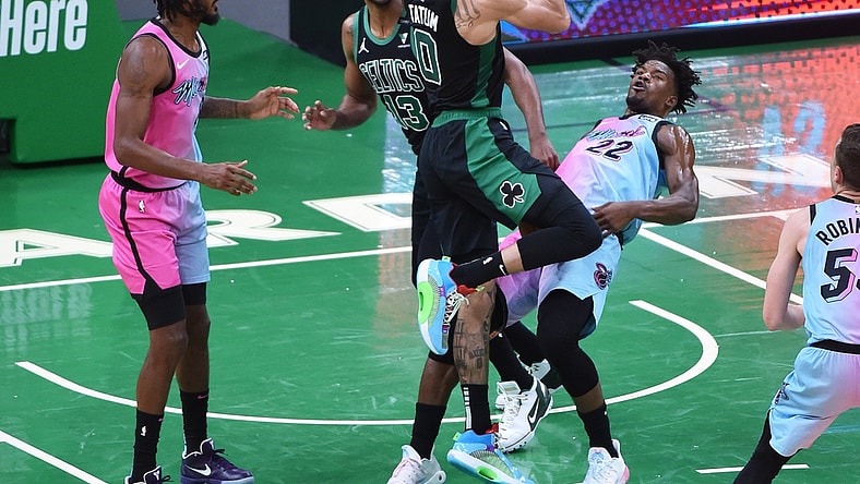 May 9, 2021; Boston, Massachusetts, USA; Boston Celtics forward Jayson Tatum (0) is called for an offensive foul on Miami Heat forward Jimmy Butler (22) during the first half at TD Garden. Mandatory Credit: Bob DeChiara-USA TODAY Sports