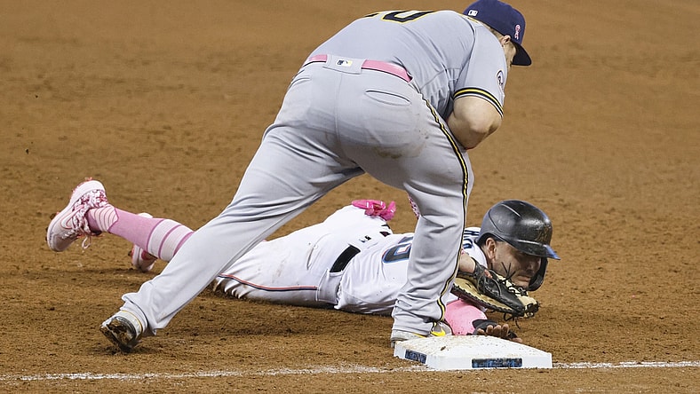 May 9, 2021; Miami, Florida, USA; Miami Marlins Miguel Rojas (bottom) gets picked off at first base by Milwaukee Brewers first baseman Daniel Vogelbach (top) during the fifth inning at loanDepot Park. Mandatory Credit: Rhona Wise-USA TODAY Sports