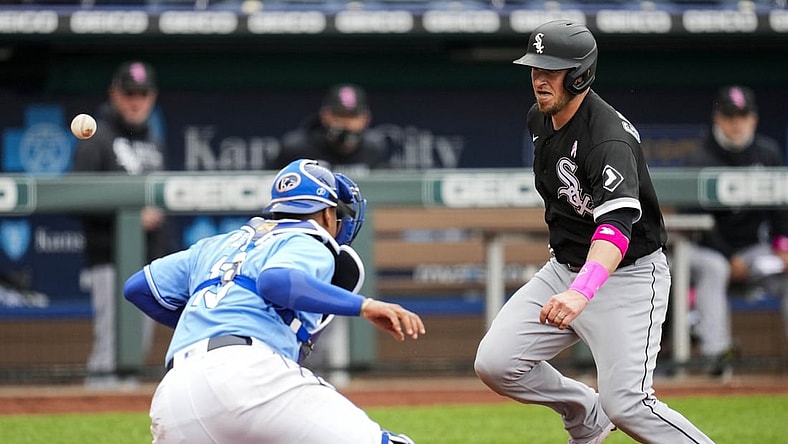 May 9, 2021; Kansas City, Missouri, USA; Chicago White Sox catcher Yasmani Grandal (R) scores a run as Kansas City Royals catcher Salvador Perez (L) is unable to make the catch during the third inning at Kauffman Stadium. Mandatory Credit: Jay Biggerstaff-USA TODAY Sports