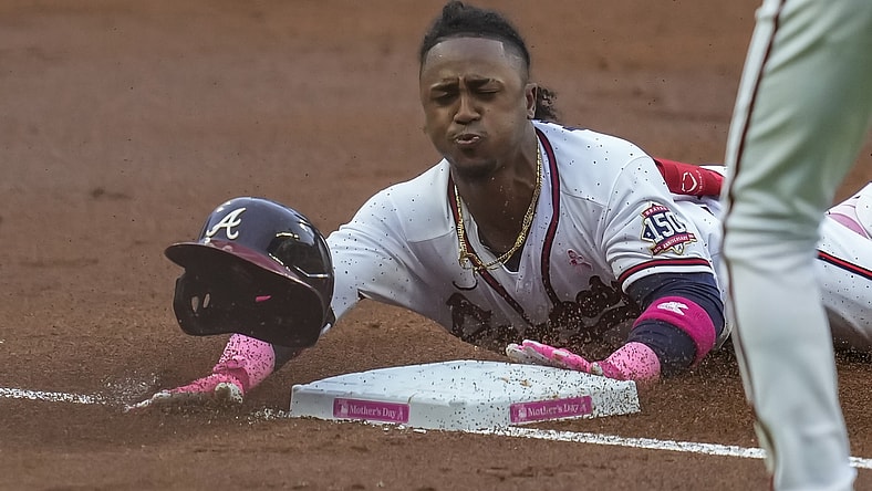May 9, 2021; Cumberland, Georgia, USA; Atlanta Braves second baseman Ozzie Albies (1) slides into third base after hitting a triple to drive in a run against the Philadelphia Phillies during the first inning at Truist Park. Mandatory Credit: Dale Zanine-USA TODAY Sports