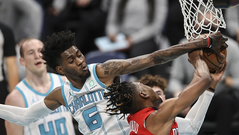 May 9, 2021; Charlotte, North Carolina, USA; Charlotte Hornets forward Jalen McDaniels (6) blocks shot by New Orleans Pelicans forward Wes Iwundu (4) in the second quarter at Spectrum Center. Mandatory Credit: Nell Redmond-USA TODAY Sports