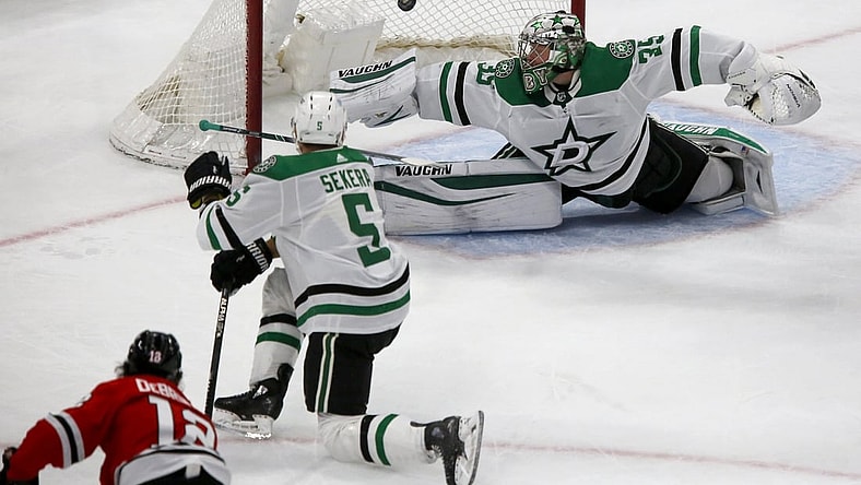 May 9, 2021; Chicago, Illinois, USA; Chicago Blackhawks left wing Alex DeBrincat (12) scores on Dallas Stars goaltender Anton Khudobin (35) during their game at United Center. Mandatory Credit: Eileen T. Meslar-USA TODAY Sports