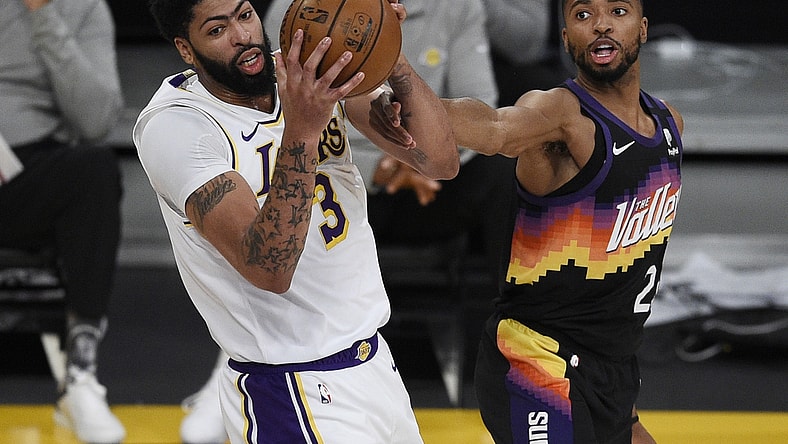 May 9, 2021; Los Angeles, California, USA; Los Angeles Lakers forward Anthony Davis (3) grabs the rebound against Phoenix Suns forward Mikal Bridges (25) during the first half at Staples Center. Mandatory Credit: Kelvin Kuo-USA TODAY Sports