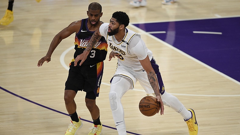 May 9, 2021; Los Angeles, California, USA; Los Angeles Lakers forward Anthony Davis (3) handles the ball while Phoenix Suns guard Chris Paul (3) defends during the second half at Staples Center. Mandatory Credit: Kelvin Kuo-USA TODAY Sports