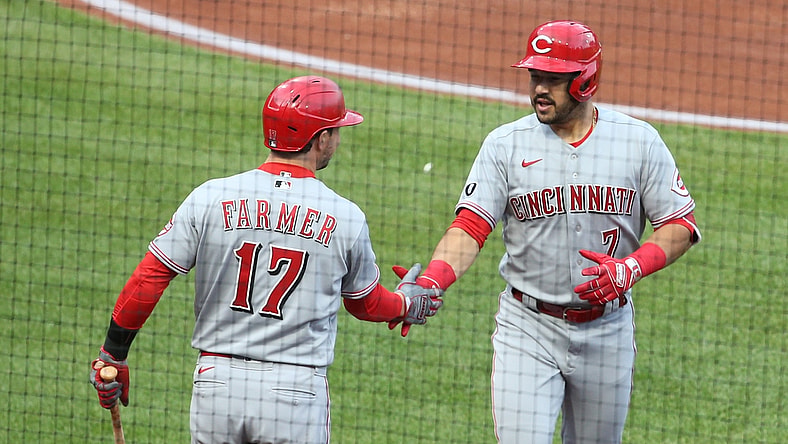 May 10, 2021; Pittsburgh, Pennsylvania, USA; Cincinnati Reds shortstop Kyle Farmer (17) congratulates first  baseman Mike Moustakas (9) on his solo home run against the Pittsburgh Pirates during the second inning at PNC Park. Mandatory Credit: Charles LeClaire-USA TODAY Sports