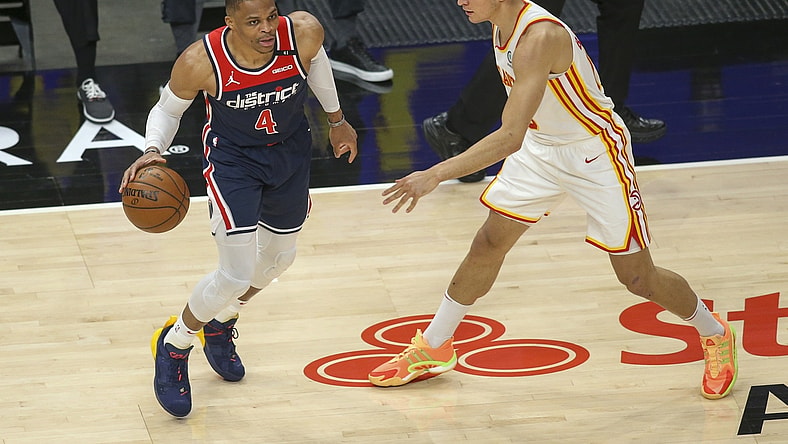 May 10, 2021; Atlanta, Georgia, USA; Washington Wizards guard Russell Westbrook (4) is defended by Atlanta Hawks guard Bogdan Bogdanovic (13) in the first quarter at State Farm Arena. Mandatory Credit: Brett Davis-USA TODAY Sports