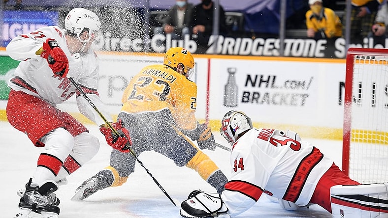 May 10, 2021; Nashville, Tennessee, USA; Nashville Predators right wing Rocco Grimaldi (23) scores a short handed goal past Carolina Hurricanes goaltender Petr Mrazek (34) during the first period at Bridgestone Arena. Mandatory Credit: Christopher Hanewinckel-USA TODAY Sports
