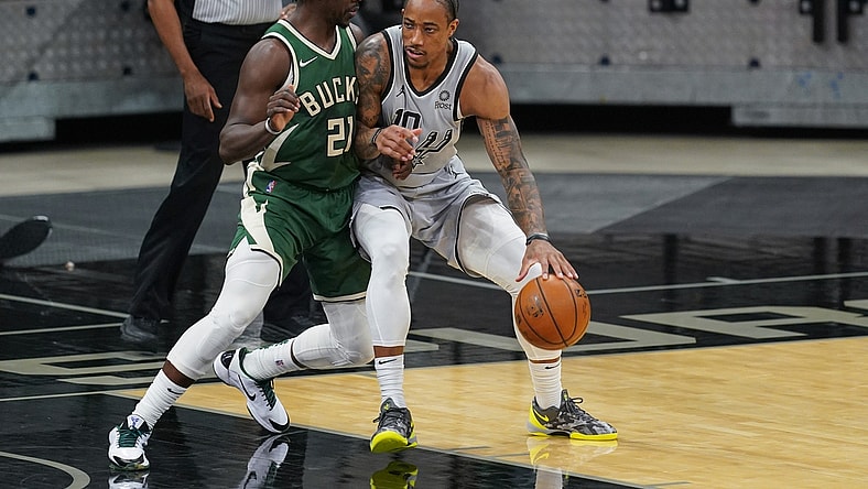 May 10, 2021; San Antonio, Texas, USA; San Antonio Spurs forward DeMar DeRozan (10) dribbles against Milwaukee Bucks guard Jrue Holiday (21) in the first half at the AT&T Center. Mandatory Credit: Daniel Dunn-USA TODAY Sports