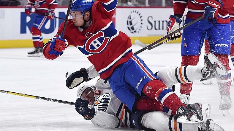 May 10, 2021; Montreal, Quebec, CAN;Montreal Canadiens forward Artturi Lehkonen (62) trips over Edmonton Oilers forward Connor McDavid (97) during the first period at the Bell Centre. Mandatory Credit: Eric Bolte-USA TODAY Sports