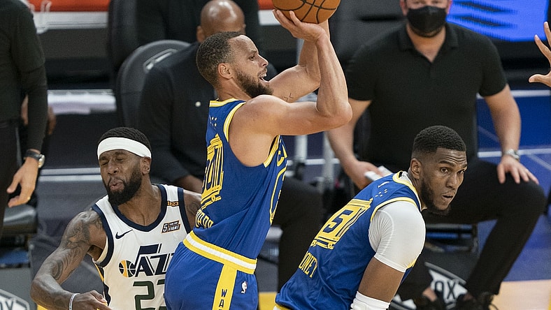 May 10, 2021; San Francisco, California, USA; Golden State Warriors guard Stephen Curry (30) shoots the basketball behind center Kevon Looney (5) against Utah Jazz forward Royce O'Neale (23) during the second quarter at Chase Center. Mandatory Credit: Kyle Terada-USA TODAY Sports