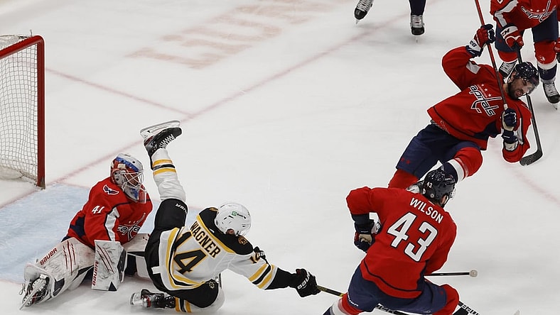 May 11, 2021; Washington, District of Columbia, USA; Boston Bruins right wing Chris Wagner (14) falls over Washington Capitals goaltender Vitek Vanecek (41) while Capitals right wing Tom Wilson (43) controls the puck in the second period at Capital One Arena. Mandatory Credit: Geoff Burke-USA TODAY Sports
