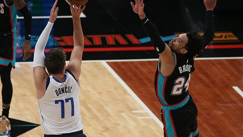 May 11, 2021; Memphis, Tennessee, USA; Memphis Grizzlies forward Dillon Brooks (24) defends Dallas Mavericks guard Luka Don  i   (77) during the first quarter  at FedExForum. Mandatory Credit: Petre Thomas-USA TODAY Sports