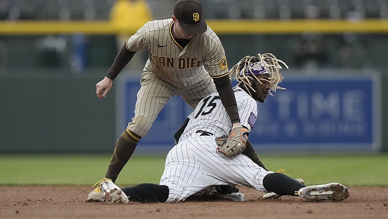 May 11, 2021; Denver, Colorado, USA; Colorado Rockies left fielder Raimel Tapia (15) slides safety under the tag of San Diego Padres second baseman Jake Cronenworth (9) in the first inning at Coors Field. Mandatory Credit: Ron Chenoy-USA TODAY Sports