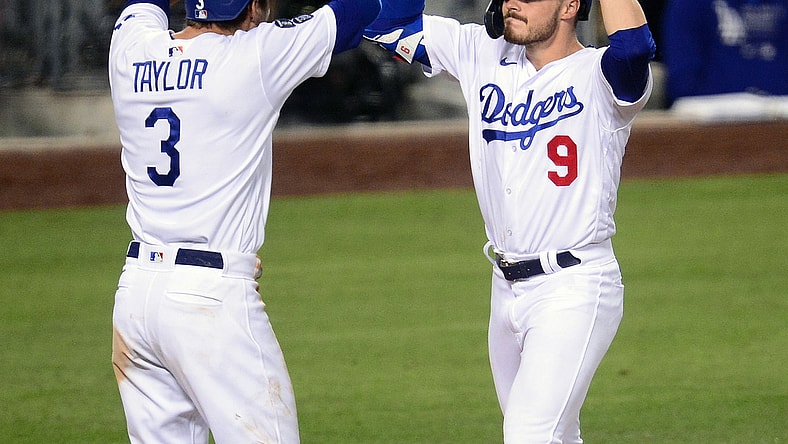 May 11, 2021; Los Angeles, California, USA; Los Angeles Dodgers second baseman Gavin Lux (9) is greeted by center fielder Chris Taylor (3) after hitting a three-run home run against the Seattle Mariners during the eighth inning at Dodger Stadium. Mandatory Credit: Gary A. Vasquez-USA TODAY Sports