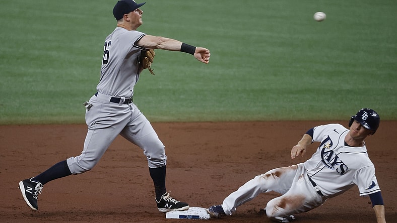 May 12, 2021; St. Petersburg, Florida, USA; New York Yankees second baseman DJ LeMahieu (26) forces out Tampa Bay Rays third baseman Joey Wendle (18) as he throws the ball to first base for a double play during the second inning at Tropicana Field. Mandatory Credit: Kim Klement-USA TODAY Sports