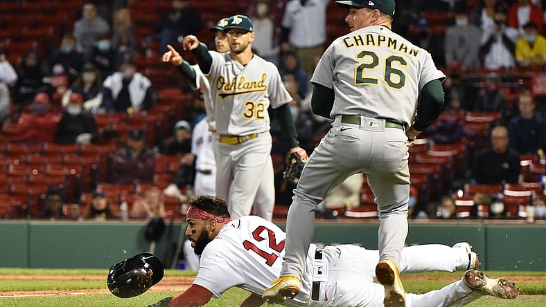 May 12, 2021; Boston, Massachusetts, USA;  Oakland Athletics third baseman Matt Chapman (26) tags out Boston Red Sox second baseman Marwin Gonzalez (12) who was caught in a run down during the fifth inning at Fenway Park. Mandatory Credit: Bob DeChiara-USA TODAY Sports
